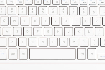 White keyboard isolated on red background.