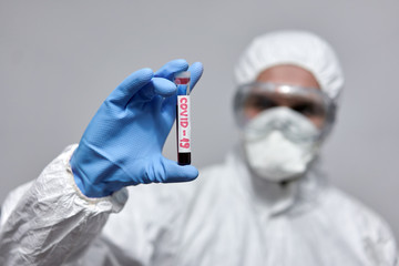 Doctor in overall suit with test tube