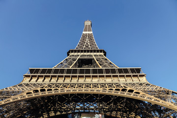 View of the Eiffel Tower from the bottom up against a cloudless sky