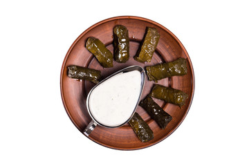 Dolma sarma or tolma stuffed grape leaves with rice, meat and white sauce cream