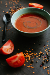 tomato soup in a bowl on wooden table