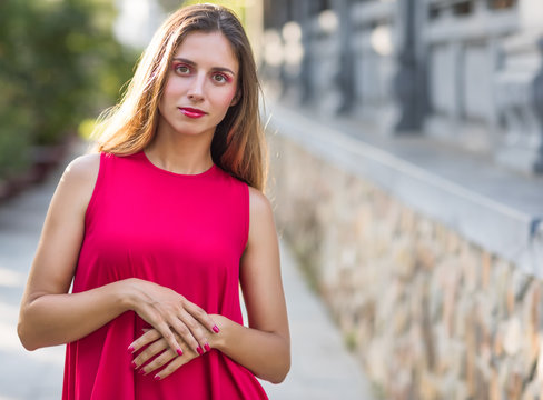 Fashion portrait of a beautiful woman in red dress