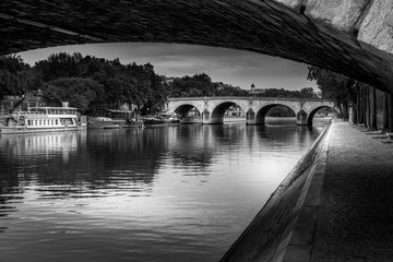 Paris, France - April 21, 2020: Bridges of Paris over Seine River in black and white during...