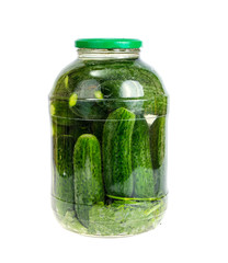 Glass jar with pickled cucumbers and herbs