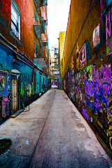Clean Concrete Alley with graffiti on both sides heavily painted in surreal colors