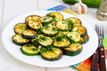 Grilled zucchini with garlic and herbs. Photo