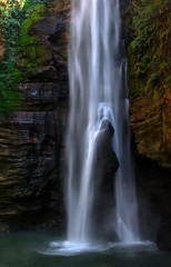 Fototapeta na wymiar Santa Barbara waterfall in chapada das mesas, Brazil. The rock inside the waterfall reminds of a woman having a shower.