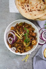 Lachha Paratha or Indian layered Roti with Pork Fry, selective focus