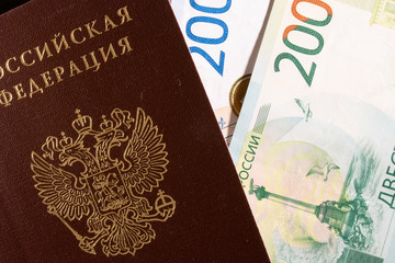 Russian banknote of two thousand and two hundred rubles with a Russian passport on a black background