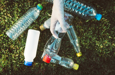 Volunteer woman holding and keep plastic bottle at public park,Dispose recycle and waste management...