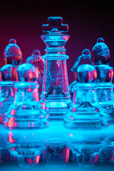 Glass chess pieces surrounding the King