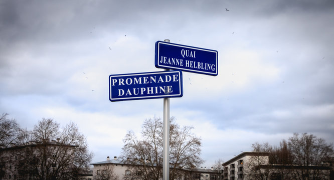 blue street sign where it is written in French Quai (dock) Jeanne Helbling and promenade Dauphine in Strasbourg