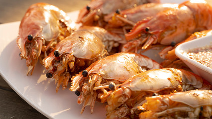 An outdoor barbecue with huge tiger prawns close up