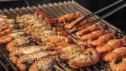 An outdoor hot barbecue with huge tiger prawns