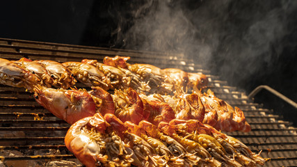 An outdoo hot barbecue with huge tiger prawns