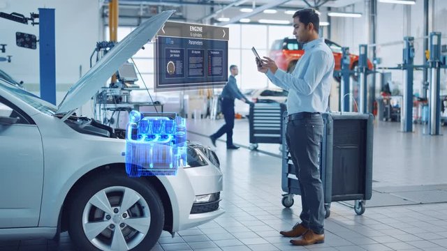 Car Service Manager Uses a Tablet Computer with a Futuristic Augmented Reality Diagnostics Software. Specialist Inspecting the V6 Internal Combustion Engine in Order to Find Broken Components.