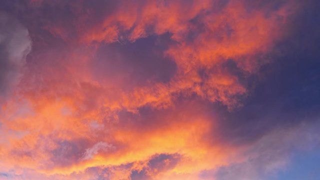 Time-lapse of orange and black clouds, sky at sunset