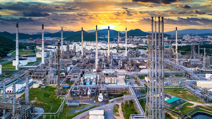 Oil and gas refinery plant and storage tank form industry zone at twilight, Aerial view oil and gas...