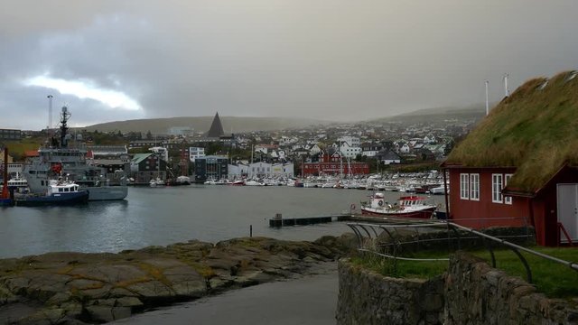 Cityscape long shot Nordic style houses with grass roof in historical district of Tinganes in Torshavn, Faroe islands