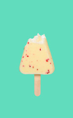white chocolate outer popsicle with a bite on green background