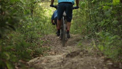 Two men mountain biking in El Salvador. - Powered by Adobe