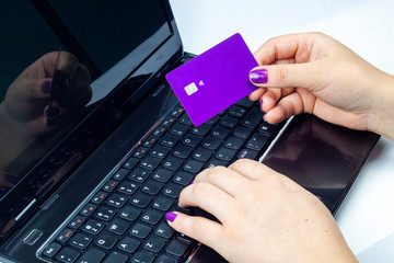 woman holding a purple card on top of a notebook