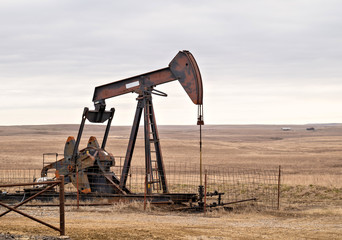 Oil Well Pump Jack pumping crude oil for fossil fuel energy. American Petroleum Oil and Gas...