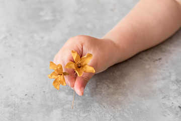 hand with yellow flower