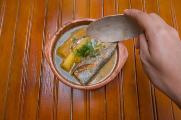 typical caribbean dish. fish soup served at the table