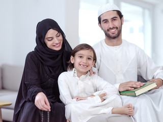 muslim family reading Quran and praying at home