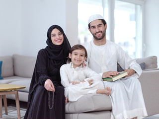 muslim family reading Quran and praying at home
