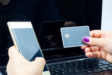 woman holding a golden cell phone with a gray on top of a notebook