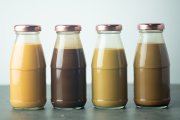 Cold coffee, cold Thai milk tea and cold cocoa in retro glass bottles