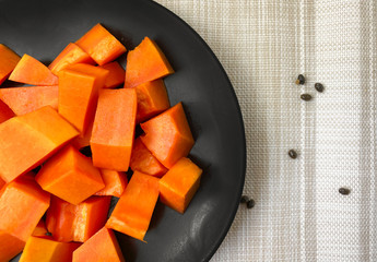Holland papaya is cooked in a black plate.