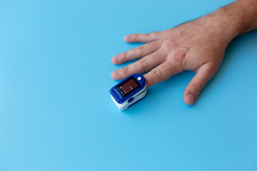 Pulse Oximeter On a male finger. Man using Oximeter. Healthy Concept