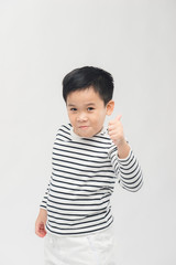 Kid giving thumbs up sign, smiling, isolated on white background