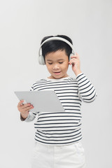 Handsome asian boy enjoying music on tablet