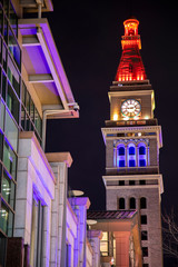 Denver, Colorado / USA - April 19, 2020: The May D&F Tower in Denver, Colorado is illuminated in blue and red to honor medical professionals during the COVID-19 health crisis.