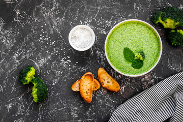 Broccoli cream soup on grey kitchen table top view