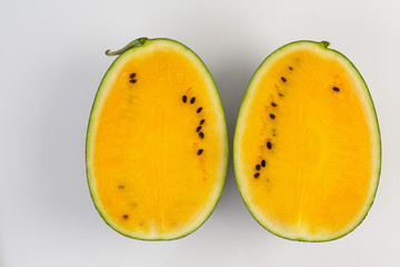 Freshly cut yellow watermelon on a white background