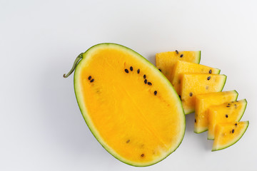 Freshly cut yellow watermelon on a white background