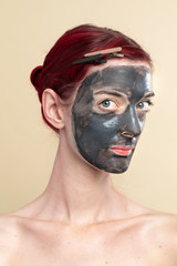 Woman doing a black charcoal mask