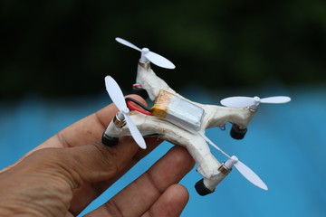 Mini drone which is having coreless motor and plastic propellers held in hand 