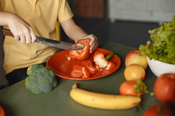 Brother and sister. Children prepare the salad. Kids in the kitchen.