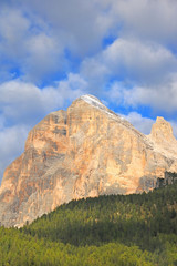 Beautiful Dolomites in Italy. Clear day with blue sky. Mountains are illuminated by the rays of the sun. Clean fresh air. Selective focus.