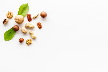 Nuts background - healthy snacks concept - on white table top-down frame copy space