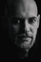 Man in sweater shaved bald head, white beard