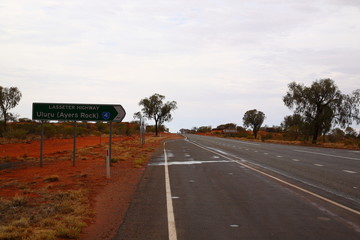 Lasseter highway Road Sign to Uluru Ayers Rock in outback central Australia.