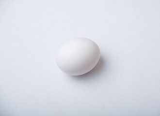 White egg on white background, concept of simplicity and clarity