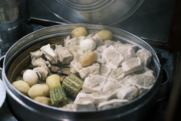 a plate of dumplings or siaw may (siomay) with peanut sauce